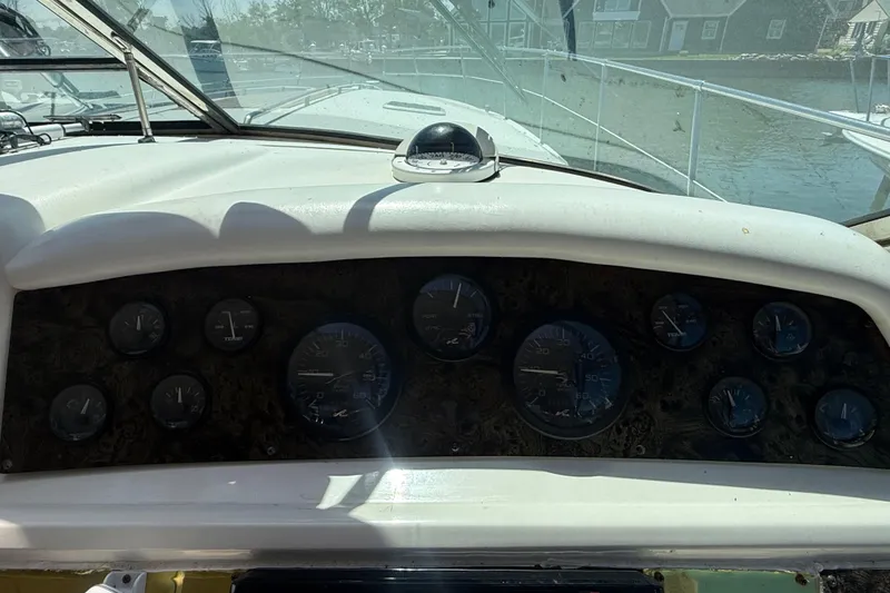Slide: The Image of Dashboard of a 1996 Sea Ray 400 Express Cruiser with gauges and controls. - 23