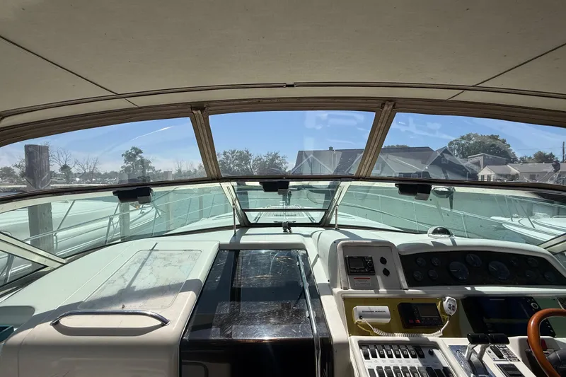 Slide: The Image of Interior view of 1996 Sea Ray 400 Express Cruiser cockpit with control panel and windshield. - 27