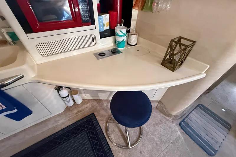 Slide: The Image of Interior of 1996 Sea Ray 400 Express Cruiser with kitchenette and seating area. - 31