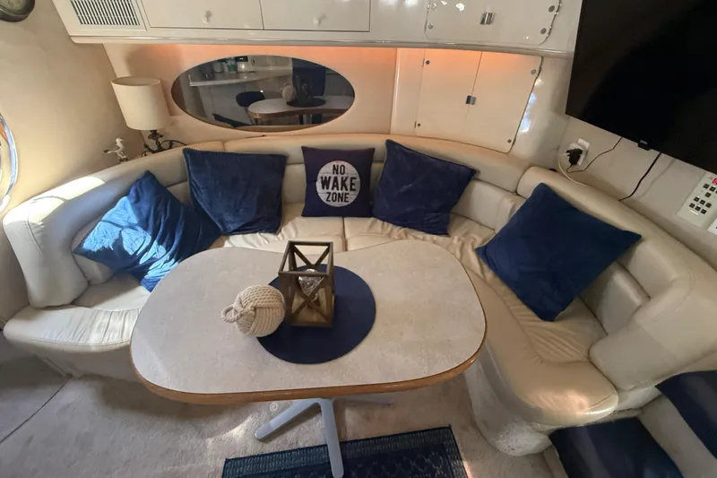 Slide: The Image of Interior of 1996 Sea Ray 400 Express Cruiser with cozy seating and nautical decor. - 37
