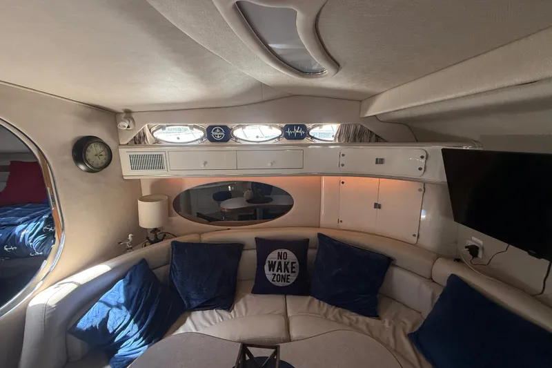 Slide: The Image of Interior of 1996 Sea Ray 400 Express Cruiser with cozy seating and nautical decor. - 38
