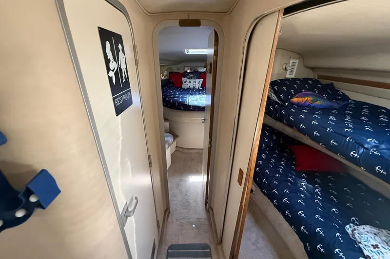 Slide: The Image of Interior of 1996 Sea Ray 400 Express Cruiser with cozy bunk beds and restroom. - 42