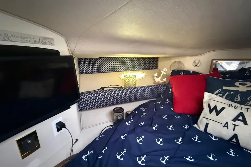 Slide: The Image of Cozy cabin interior of 1996 Sea Ray 400 Express Cruiser with nautical decor and bedding. - 46