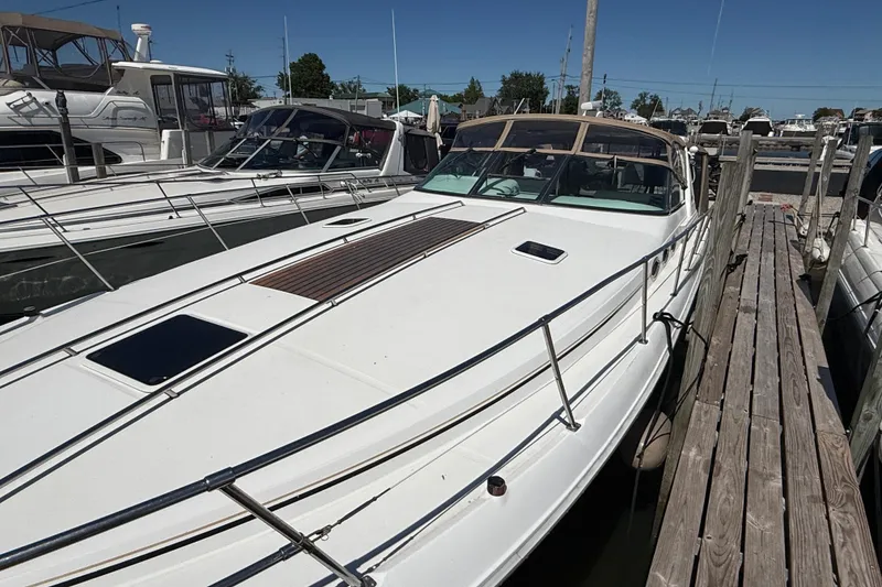 Slide: The Image of 1996 Sea Ray 400 Express Cruiser docked at a marina under clear blue skies. - 5