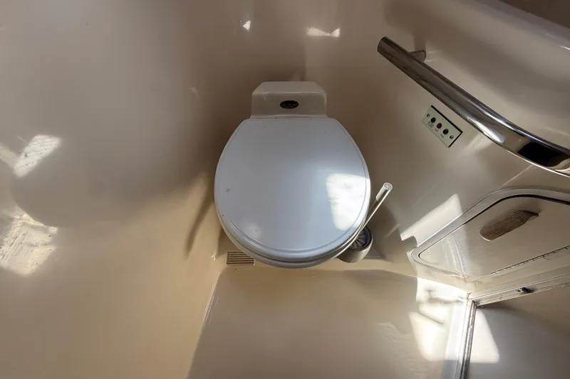 Slide: The Image of 1996 Sea Ray 400 Express Cruiser bathroom with toilet and handrail. - 53