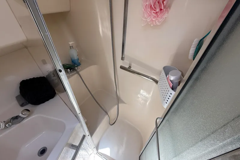 Slide: The Image of Bathroom of 1996 Sea Ray 400 Express Cruiser with shower and toiletries. - 54