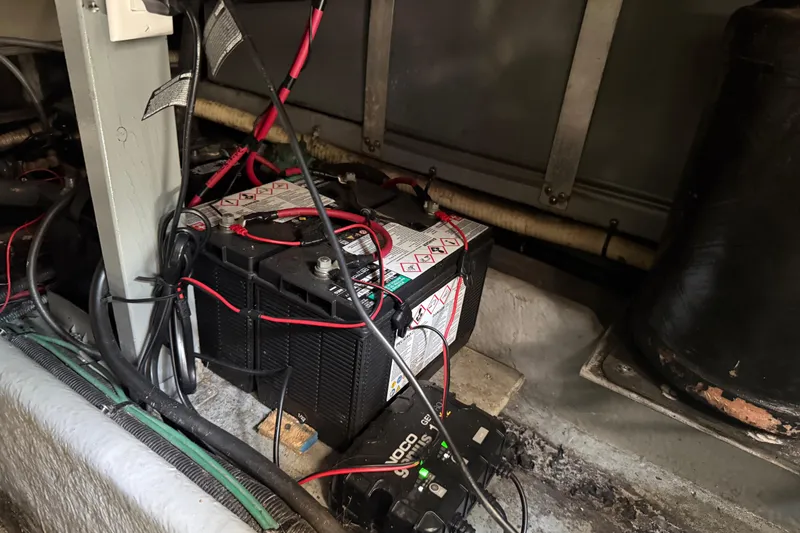 Slide: The Image of Battery setup in a 1996 Sea Ray 400 Express Cruiser engine compartment. - 61