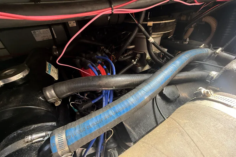 Slide: The Image of Engine compartment of a 1996 Sea Ray 400 Express Cruiser with visible hoses and wiring. - 63