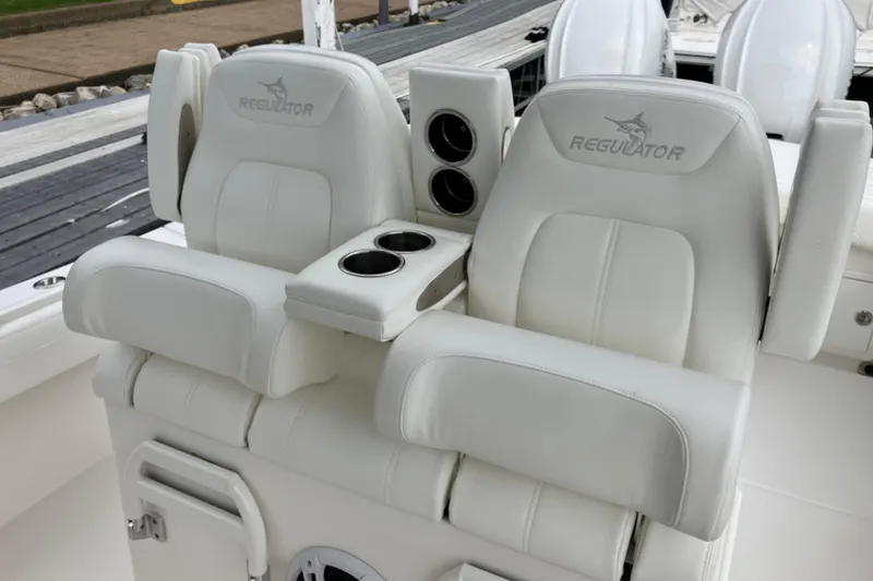 Slide: The Image of 2021 Regulator 31 boat seats with cup holders, featuring white upholstery. - 14