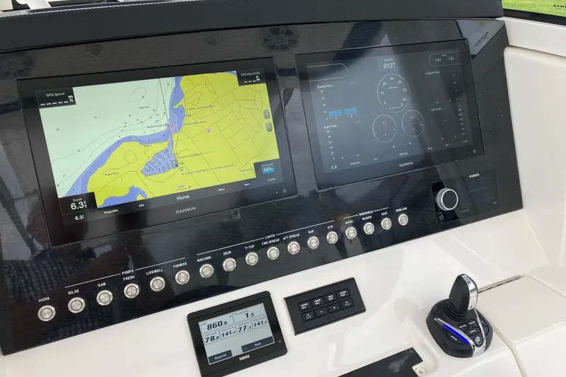 Slide: The Image of Dashboard of a 2021 Regulator 31 boat featuring Garmin navigation displays. - 12