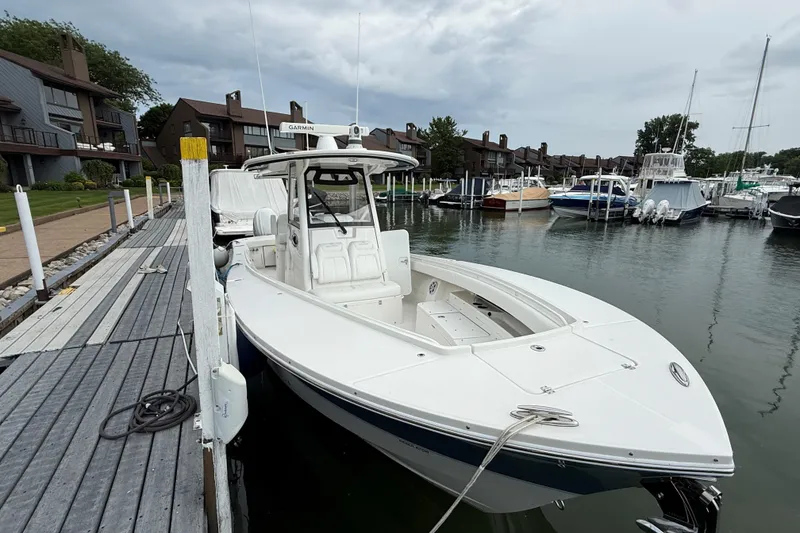 Slide: The Image of 2021 Regulator 31 boat docked at a marina with overcast skies. - 9