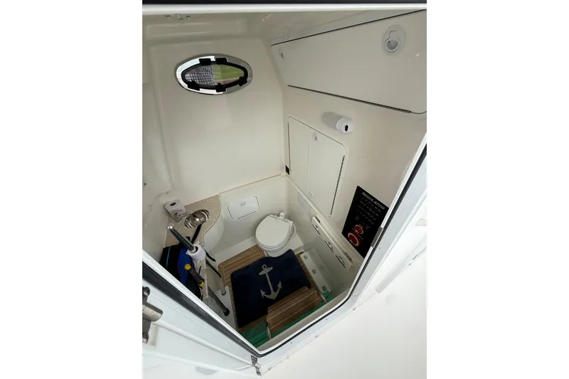 Slide: The Image of 2021 Regulator 31 boat interior with compact bathroom and nautical decor. - 11