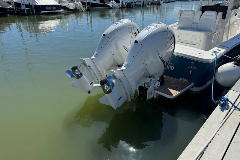 Slide: The Image of 2021 Regulator 31 boat with dual outboard engines docked in marina. - 3