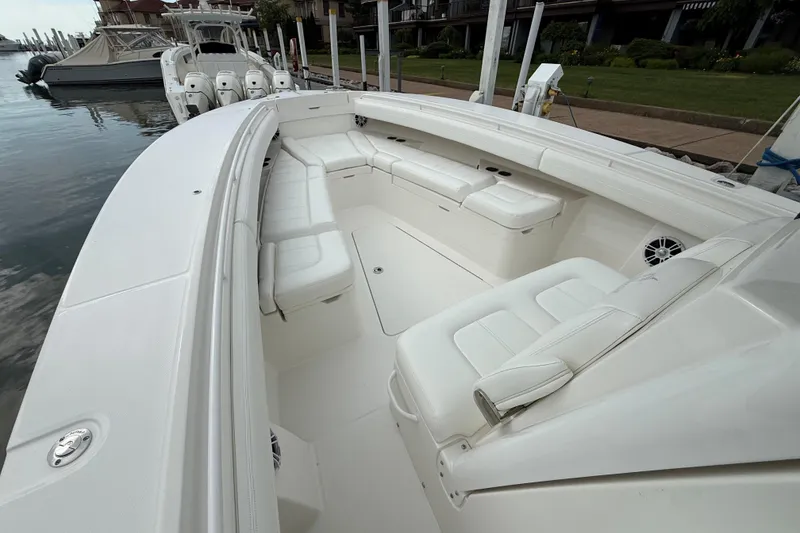 Slide: The Image of 2021 Regulator 31 boat with spacious white seating and sleek design at a dock. - 8