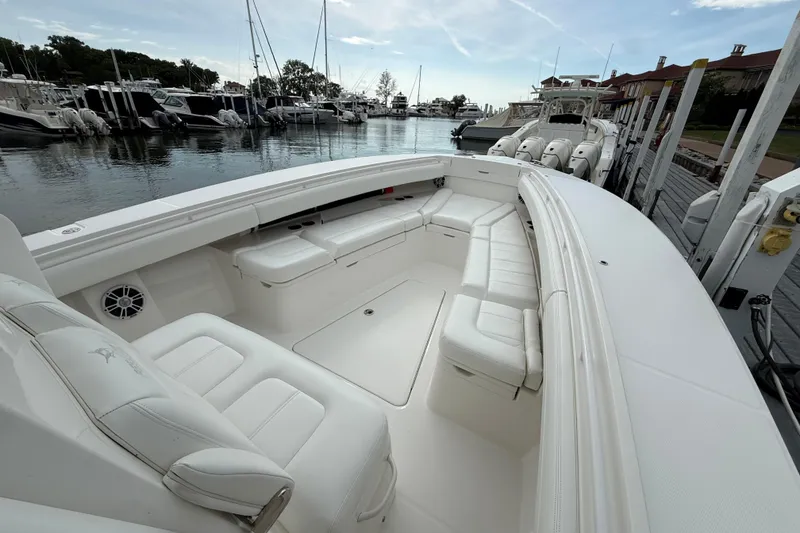 Slide: The Image of 2021 Regulator 31 boat with spacious white seating at a marina. - 7