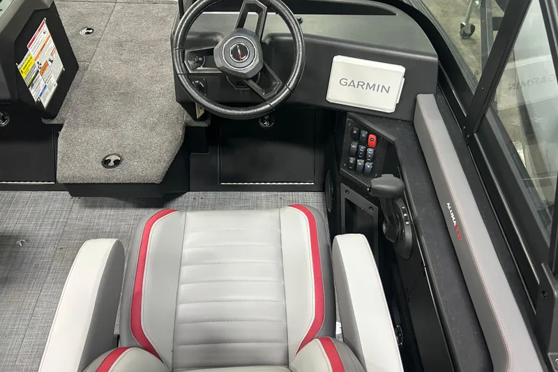 Slide: The Image of 2025 Alumacraft Trophy 185X Sport boat interior with Garmin navigation system and steering wheel. - 12