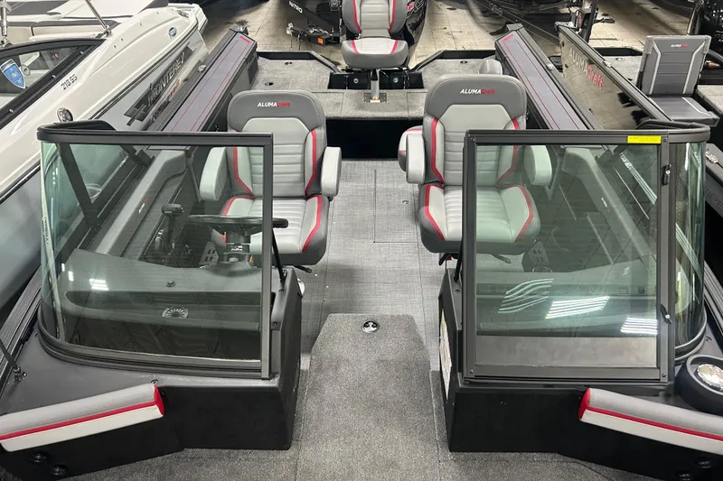 Slide: The Image of 2025 Alumacraft Trophy 185X Sport interior with dual seats and windshield. - 14