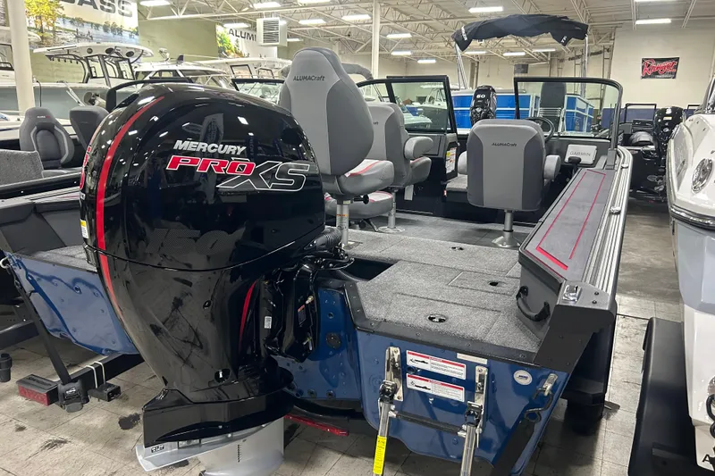 Slide: The Image of 2025 Alumacraft Trophy 185X Sport boat with Mercury Pro XS engine in showroom. - 4