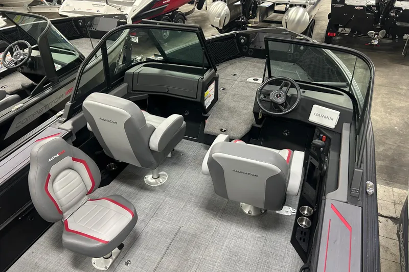 Slide: The Image of 2025 Alumacraft Trophy 185X Sport boat interior with seating and Garmin navigation system. - 6