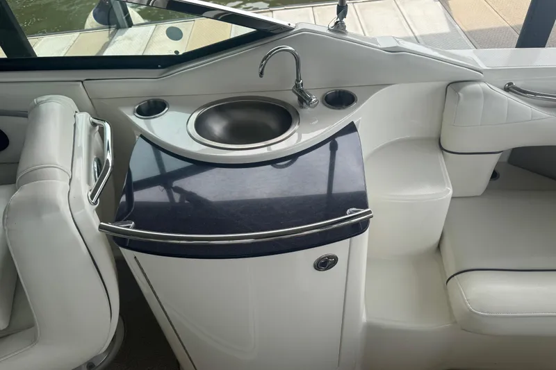 Slide: The Image of Interior of 2006 Sea Ray 270 SLX boat with sink and seating area. - 14
