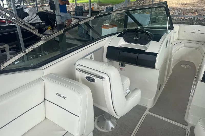 Slide: The Image of Interior of a 2006 Sea Ray 270 SLX boat with white seating and sleek dashboard. - 15