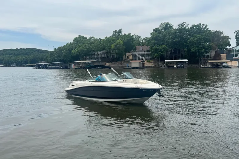 Slide: The Image of 2006 Sea Ray 270 SLX boat on a calm lake with wooded shoreline. - 17