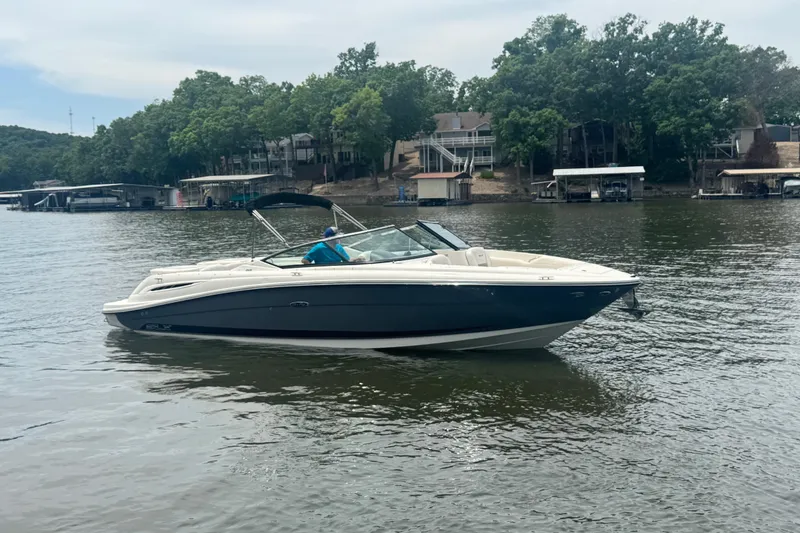 Slide: The Image of 2006 Sea Ray 270 SLX boat on a calm lake with wooded shoreline. - 2