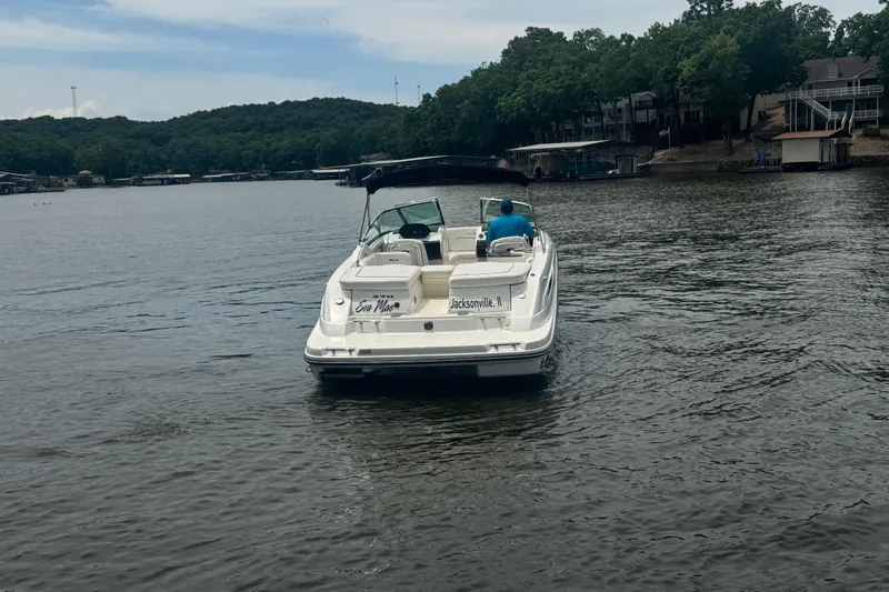 Slide: The Image of 2006 Sea Ray 270 SLX boat cruising on a lake with scenic shoreline. - 4
