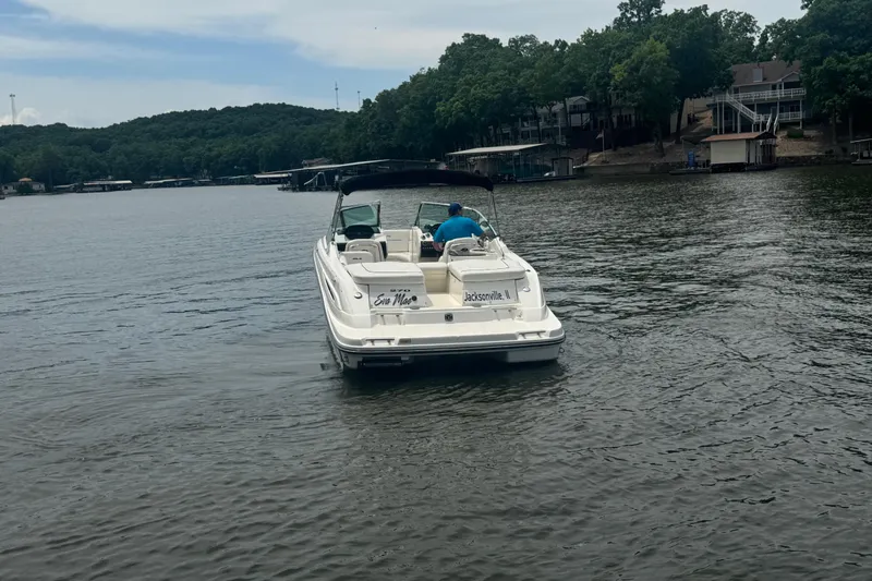 Slide: The Image of 2006 Sea Ray 270 SLX boat cruising on a serene lake with wooded shoreline. - 5