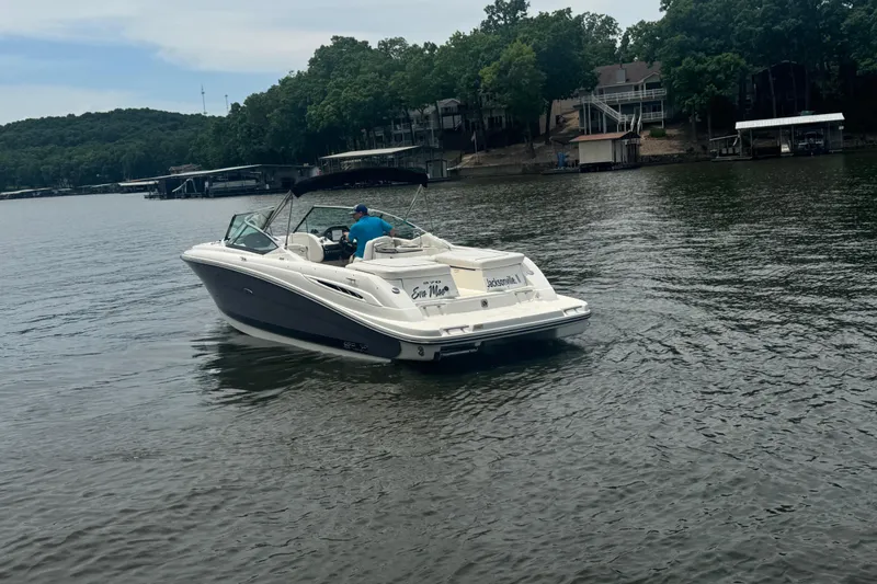 Slide: The Image of 2006 Sea Ray 270 SLX boat cruising on a lake near wooded shoreline. - 6