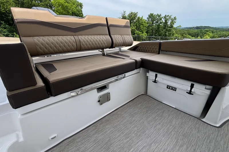 Slide: The Image of 2026 Monterey Elite 27 OB boat interior with brown seating and Yeti cooler. - 10