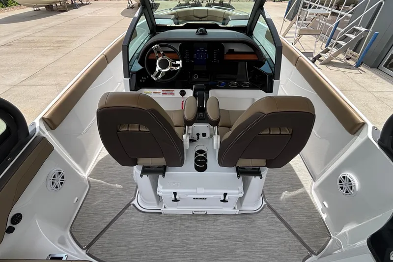 Slide: The Image of Interior view of 2026 Monterey Elite 27 OB boat cockpit with dual seats and steering wheel. - 11
