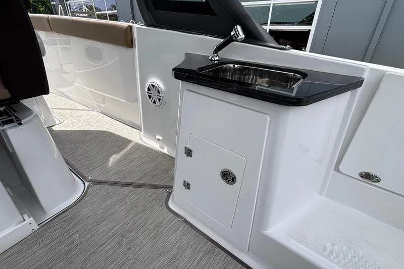 Slide: The Image of 2026 Monterey Elite 27 OB boat interior with sink and storage cabinet. - 12