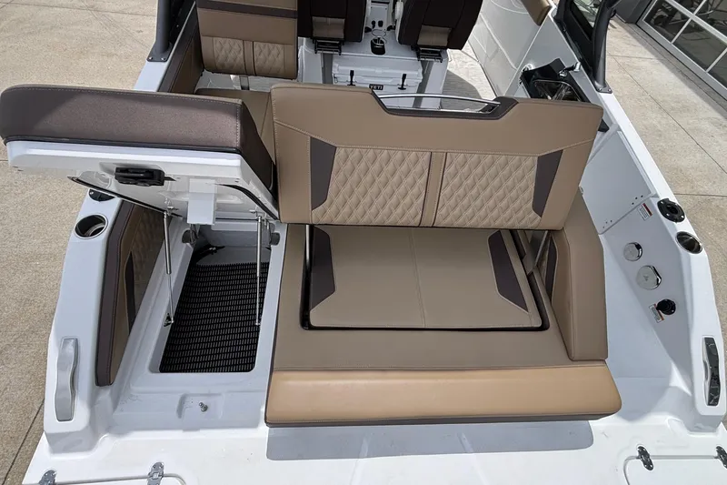 Slide: The Image of 2026 Monterey Elite 27 OB boat interior with luxurious tan seating and modern design. - 17