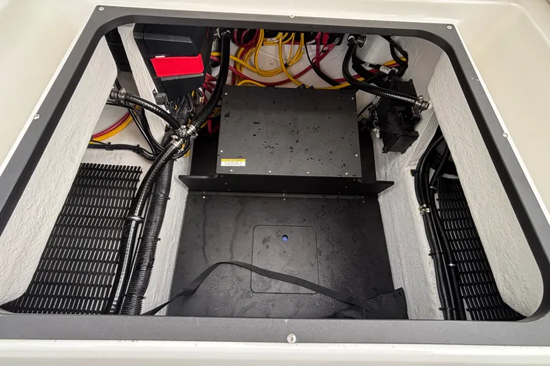 Slide: The Image of Engine compartment of 2026 Monterey Elite 27 OB boat, showcasing wiring and components. - 19