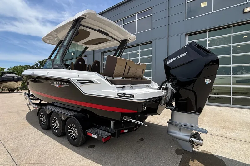 Slide: The Image of 2026 Monterey Elite 27 OB boat with Mercury outboard engine on a trailer. - 2
