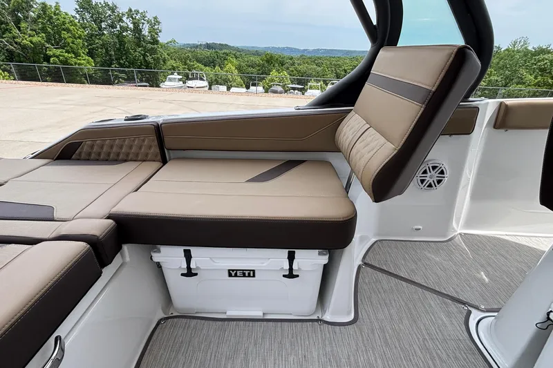 Slide: The Image of Interior of 2026 Monterey Elite 27 OB boat with cushioned seating and Yeti cooler. - 20