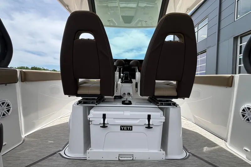 Slide: The Image of 2026 Monterey Elite 27 OB boat interior with dual seats and Yeti cooler. - 23