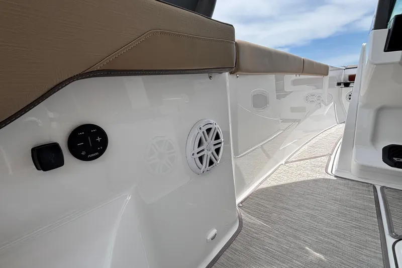 Slide: The Image of Interior view of 2026 Monterey Elite 27 OB boat, featuring sleek seating and audio controls. - 24