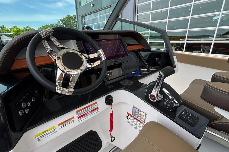 Slide: The Image of 2026 Monterey Elite 27 OB boat dashboard with modern steering and controls. - 26