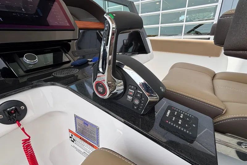 Slide: The Image of Control panel of a 2026 Monterey Elite 27 OB boat with modern features. - 27
