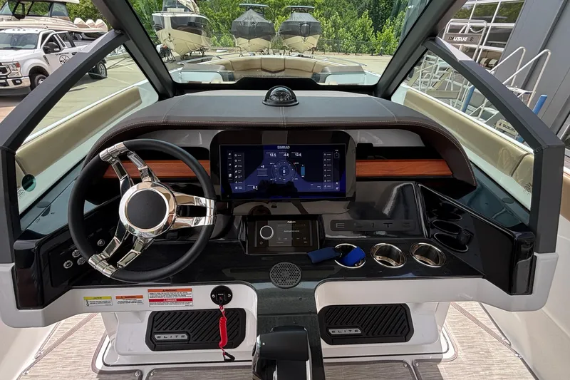 Slide: The Image of Cockpit of 2026 Monterey Elite 27 OB boat with modern steering and digital display. - 29