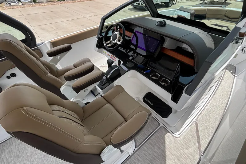 Slide: The Image of Luxurious interior of 2026 Monterey Elite 27 OB boat with modern dashboard and seating. - 30