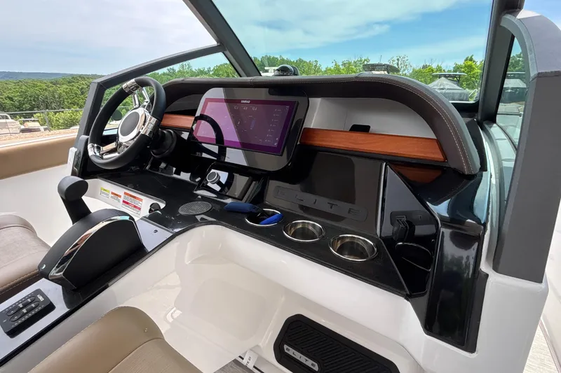 Slide: The Image of 2026 Monterey Elite 27 OB boat dashboard with modern controls and touchscreen display. - 31