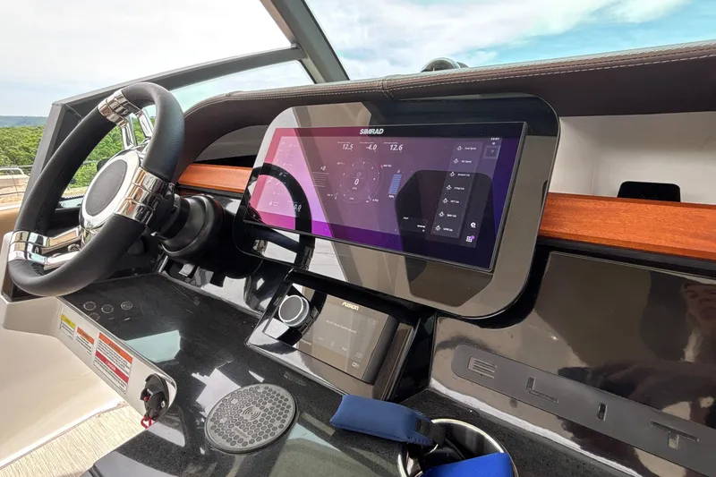 Slide: The Image of Helm of 2026 Monterey Elite 27 OB with advanced Simrad navigation display. - 32