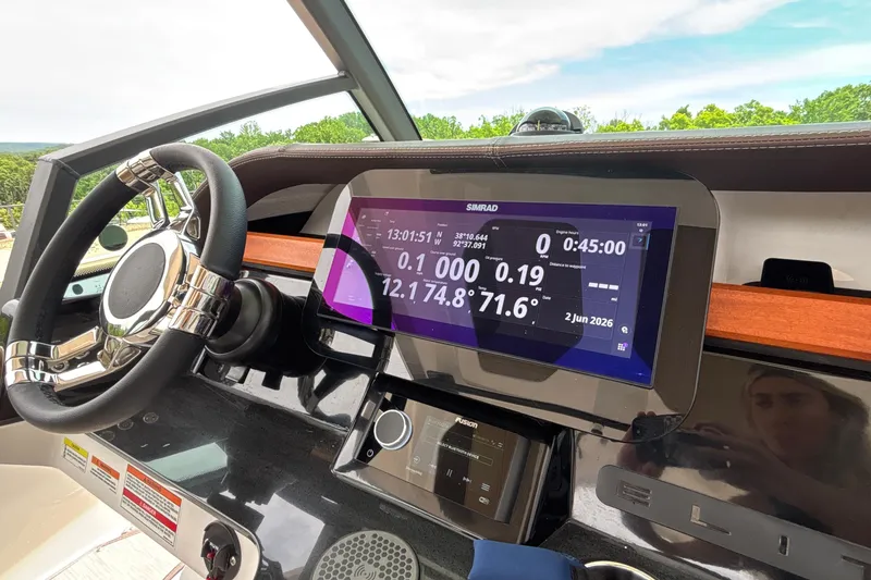 Slide: The Image of Steering wheel and dashboard of 2026 Monterey Elite 27 OB boat with digital display. - 33