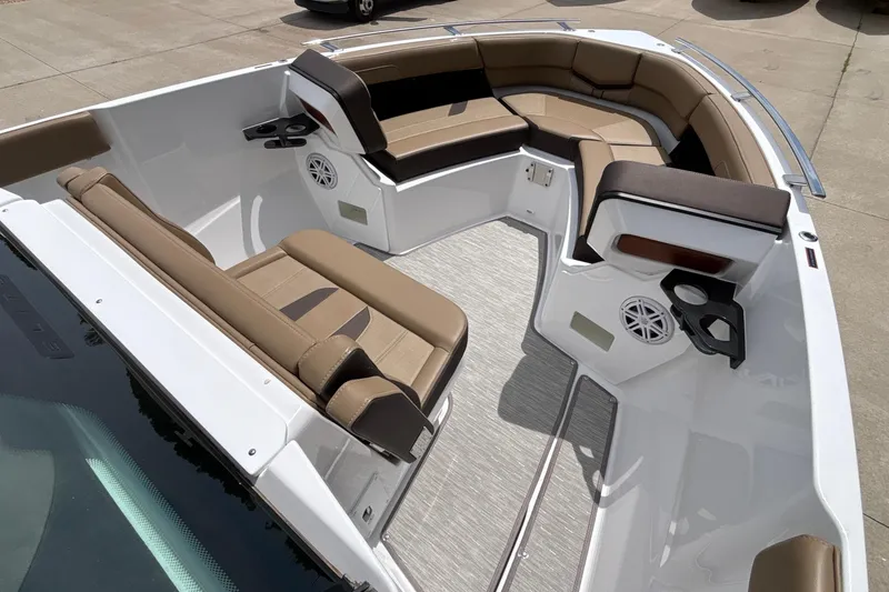 Slide: The Image of 2026 Monterey Elite 27 OB boat interior with tan seating and cup holders. - 35