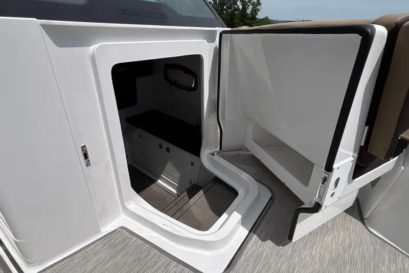 Slide: The Image of 2026 Monterey Elite 27 OB boat interior with open storage compartment and sleek design. - 48