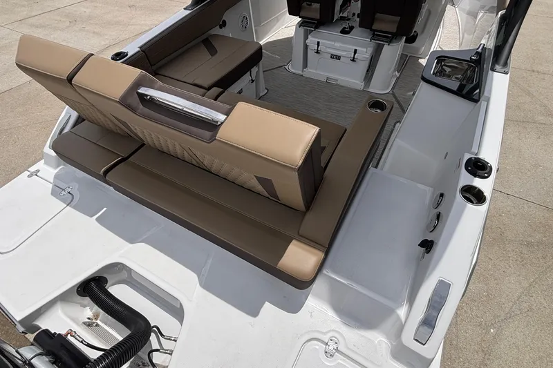 Slide: The Image of 2026 Monterey Elite 27 OB boat interior with tan seating and modern design. - 5
