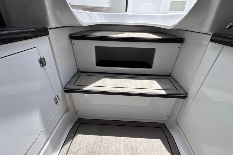 Slide: The Image of Interior steps of 2026 Monterey Elite 27 OB boat, featuring sleek design and storage. - 54